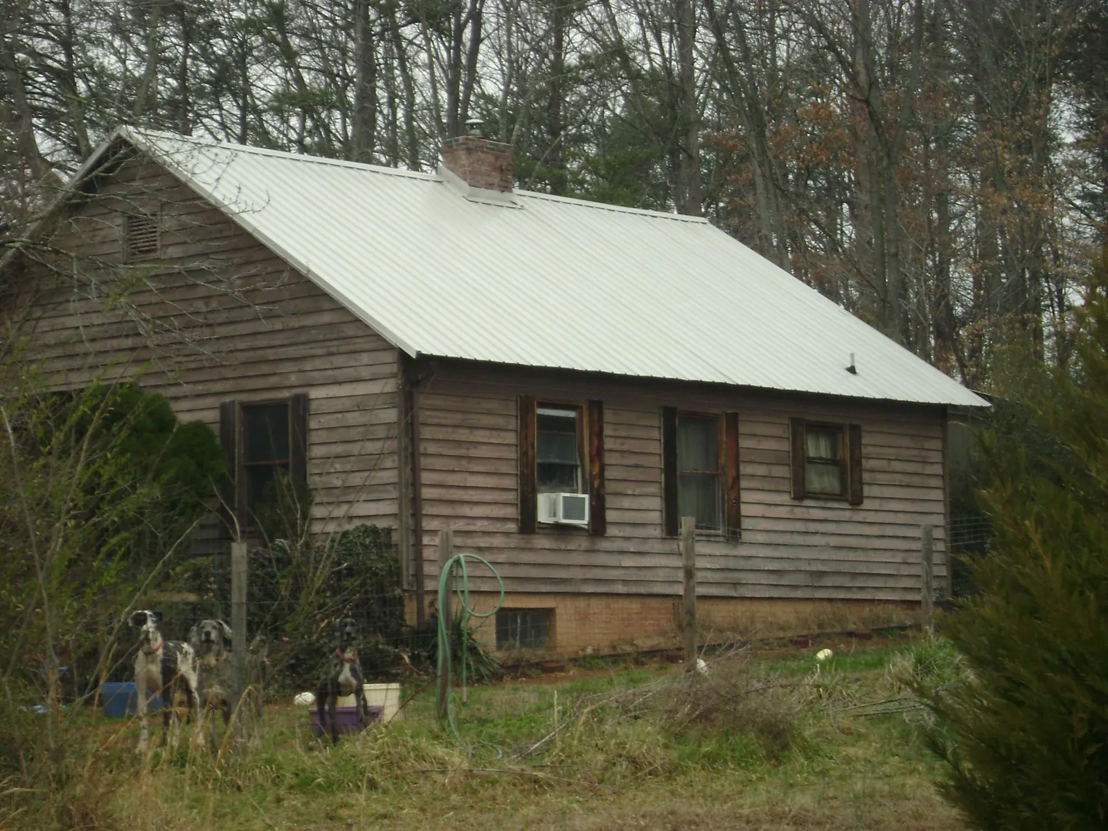 White metal roof on an old wood sided farmhouse, from a Metal Roof Installation job in Avalon