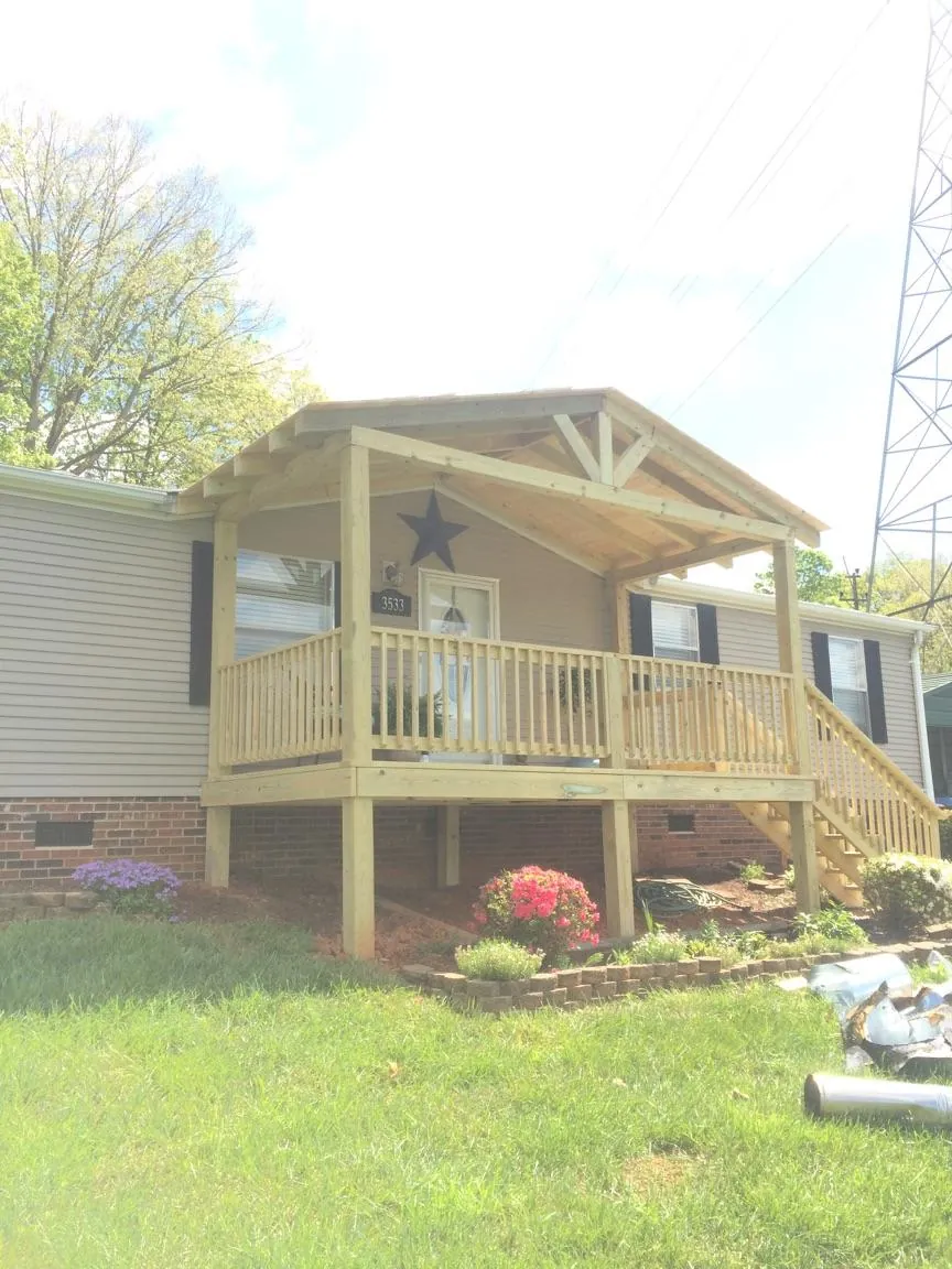 New gabled porch roof and deck railing added to a ranch home in Avalon